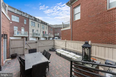 a view of a patio with table and chairs