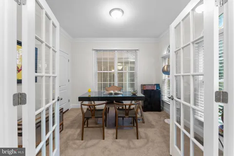 a view of a dining room with furniture and a window