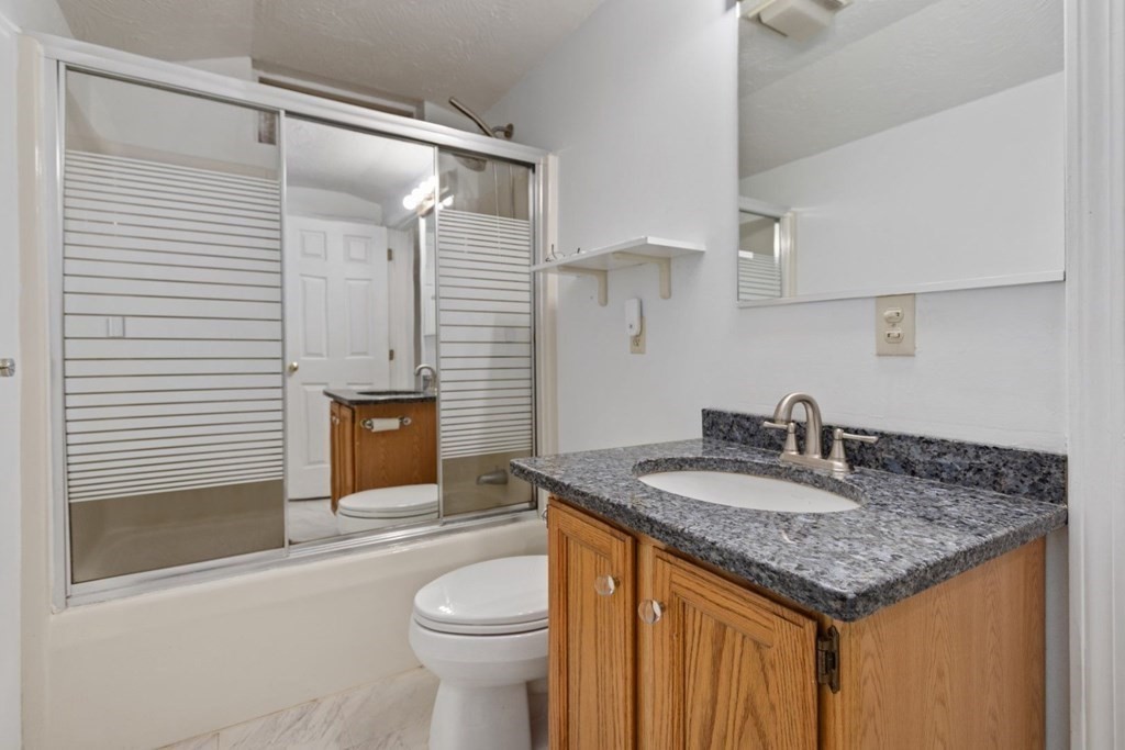 1 Hammersmith Drive Saugus, MA 01906 - Photo 14 of 39 a bathroom with a granite countertop sink and a mirror