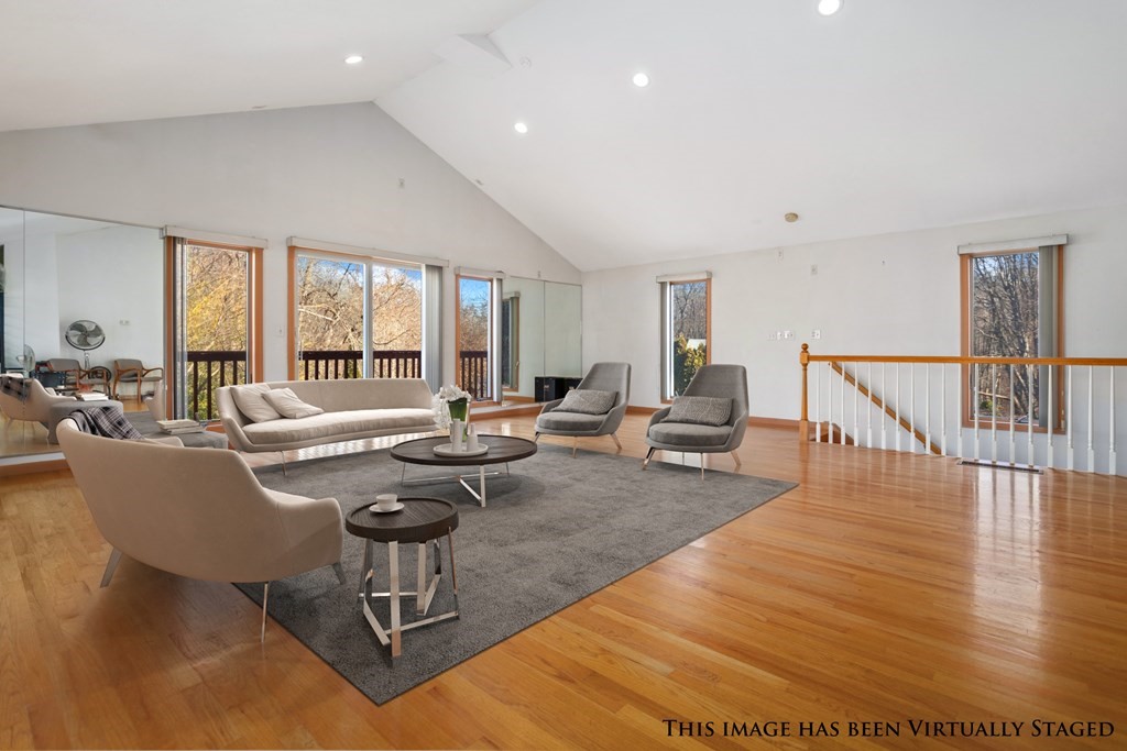 1 Hammersmith Drive Saugus, MA 01906 - Photo 19 of 39 a living room with couches and a dining table with wooden floor