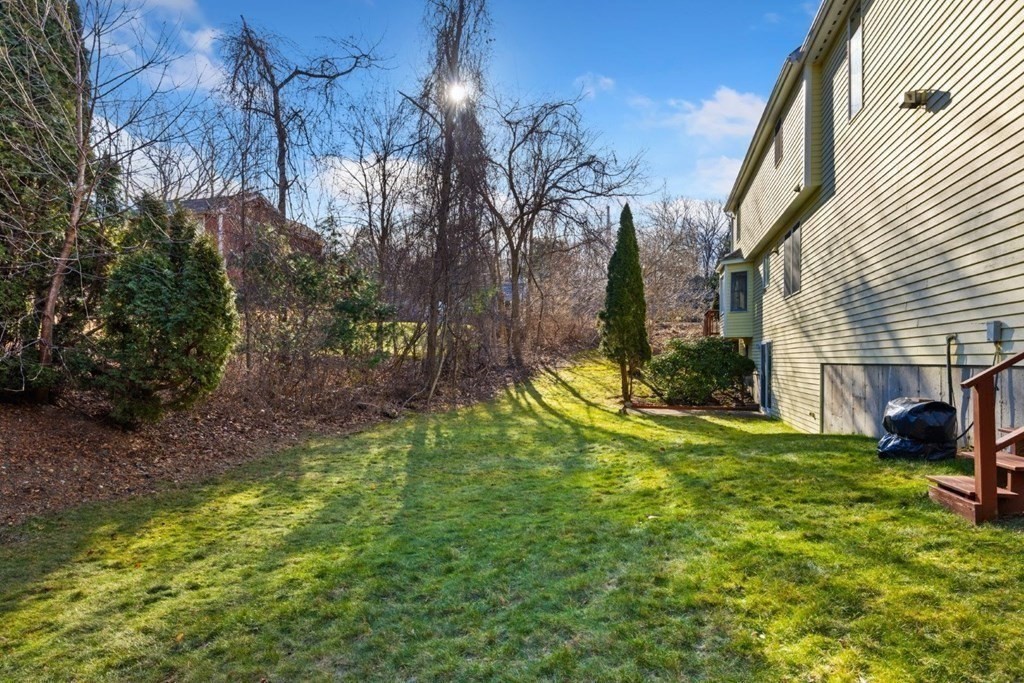 1 Hammersmith Drive Saugus, MA 01906 - Photo 27 of 39 a view of a backyard with plants and large trees