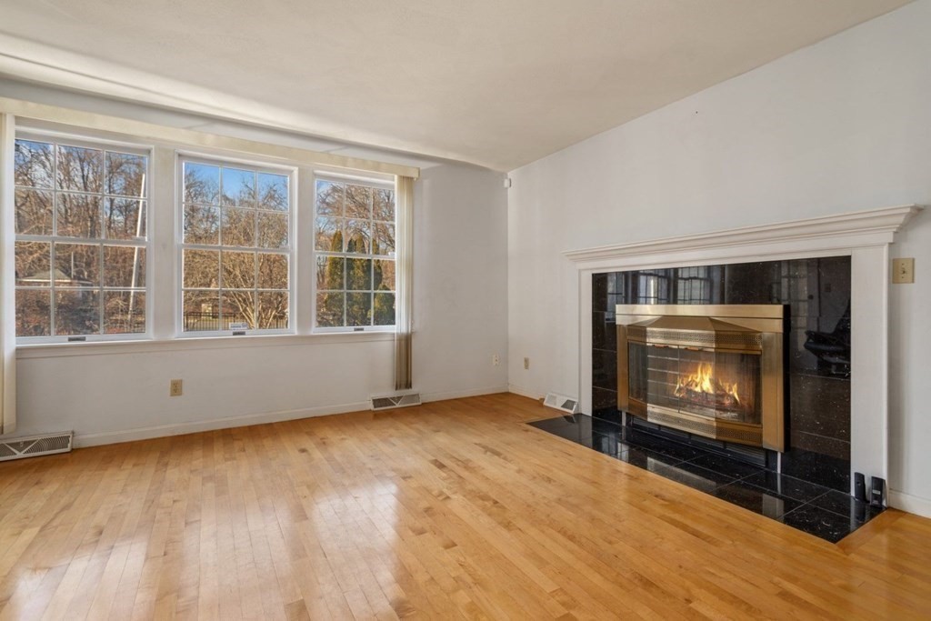 1 Hammersmith Drive Saugus, MA 01906 - Photo 4 of 39 a view of an empty room with a fireplace and a window