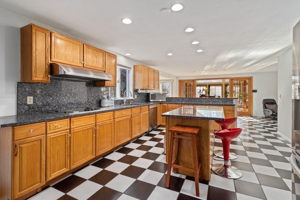 1 Hammersmith Drive Saugus, MA 01906 - Photo 7 of 39 a kitchen with stainless steel appliances granite countertop a sink and a stove