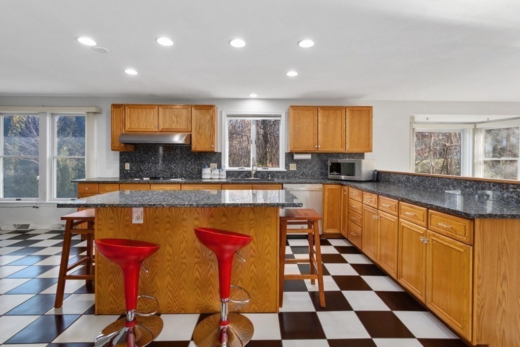 1 Hammersmith Drive Saugus, MA 01906 - Photo 8 of 39 a kitchen with stainless steel appliances granite countertop a stove a sink and a refrigerator