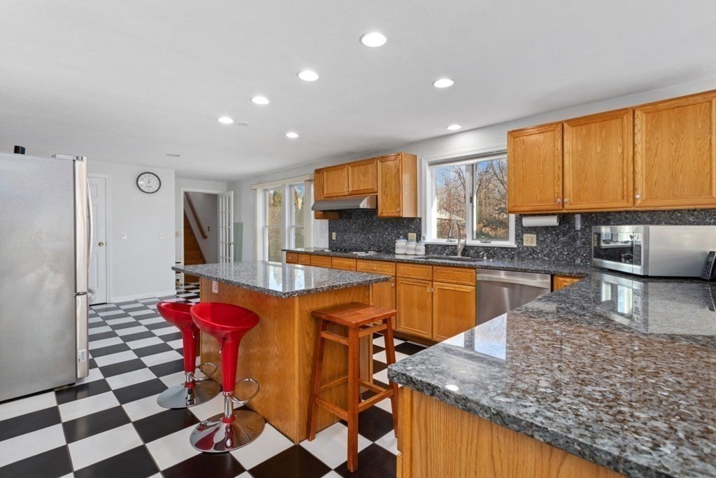 1 Hammersmith Drive Saugus, MA 01906 - Photo 9 of 39 a kitchen with stainless steel appliances granite countertop a sink and a counter space