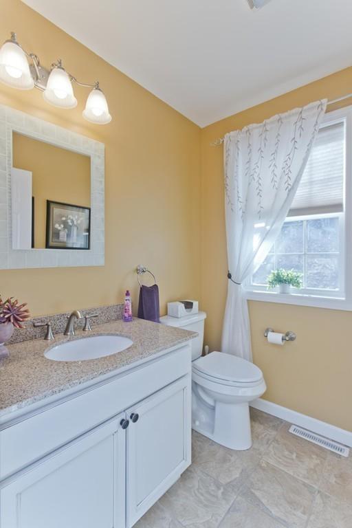 445 Monson Road Wilbraham, MA 01095 - Photo 15 of 42 a bathroom with a granite countertop sink mirror vanity and toilet