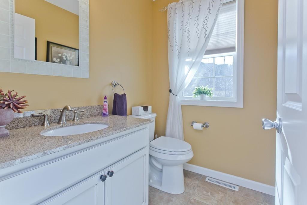 445 Monson Road Wilbraham, MA 01095 - Photo 16 of 42 a bathroom with a granite countertop sink a toilet and a mirror