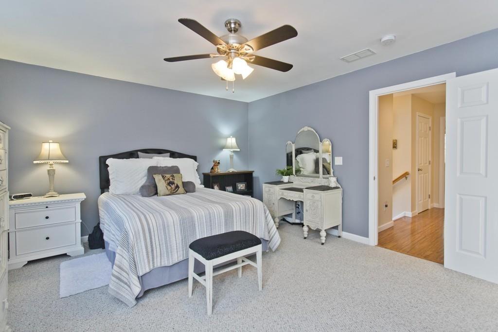 445 Monson Road Wilbraham, MA 01095 - Photo 26 of 42 a bedroom with a bed and a chandelier