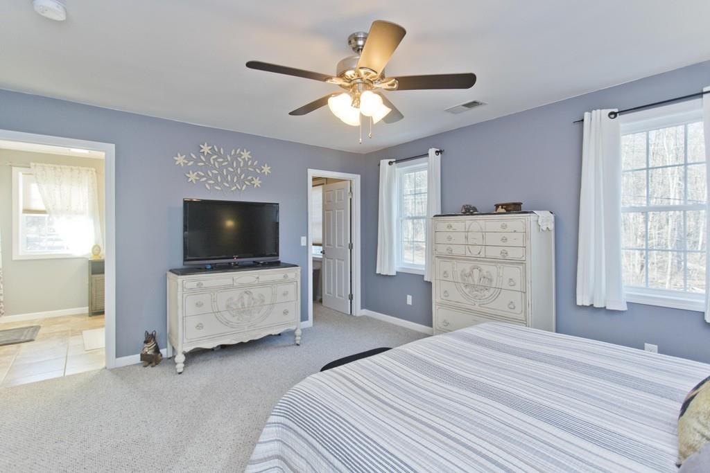 445 Monson Road Wilbraham, MA 01095 - Photo 28 of 42 a bedroom with a bed and a flat screen tv