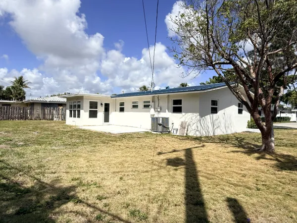 a front view of house with yard patio and swimming pool
