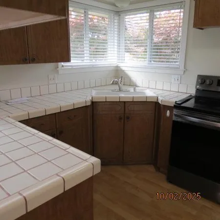 a kitchen with a stove and a refrigerator