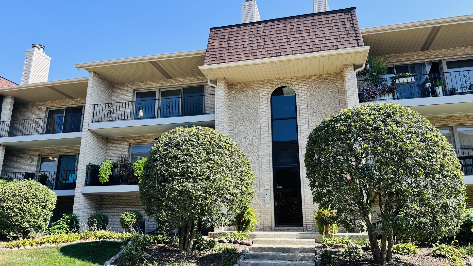 a front view of a house with garden