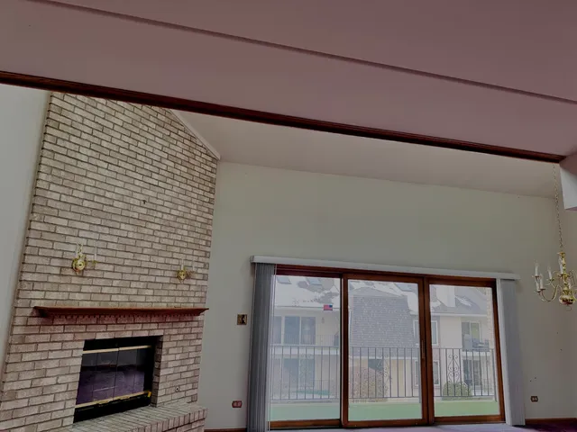 a view of a livingroom with a chandelier wooden floor and a chandelier