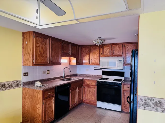 a front view of a house with a tree