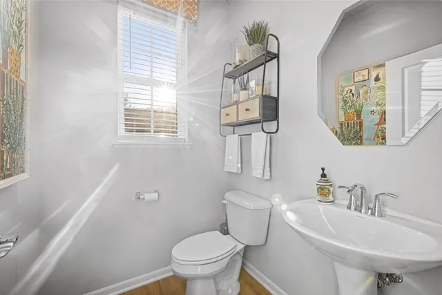 a white toilet sitting next to a bathroom sink