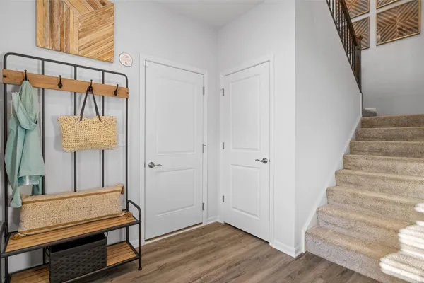 a view of entryway and hall with wooden floor