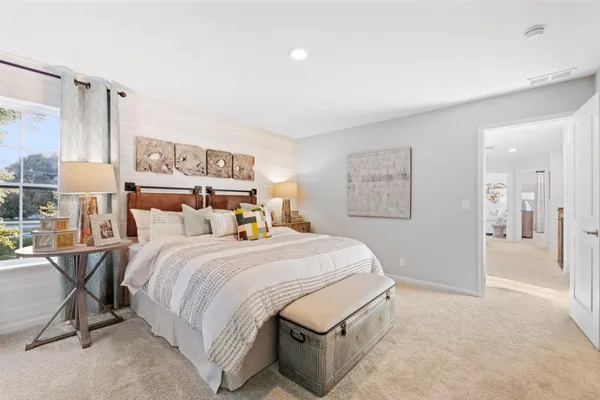 a bedroom with a bed and a table