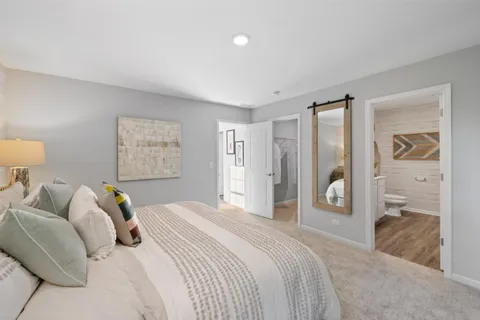 a bedroom with a bed and a couch