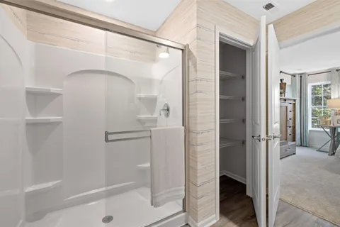 a bathroom with a glass shower door