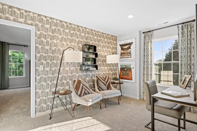a living room with furniture and a floor to ceiling window