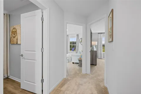 a view of a hallway with wooden floor and windows