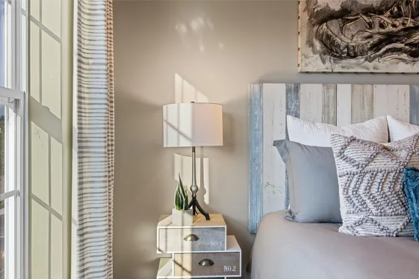 a bedroom with furniture and a window