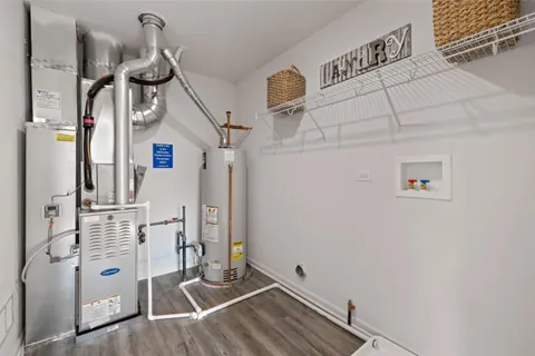 a view of a patio with couches chairs potted plants and floor to ceiling window