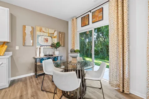 a dining room with furniture a rug and wooden floor