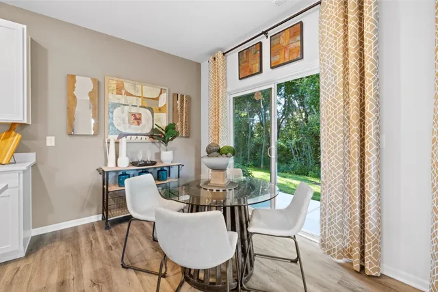 a dining room with furniture a rug and wooden floor