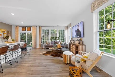a living room with furniture and large windows