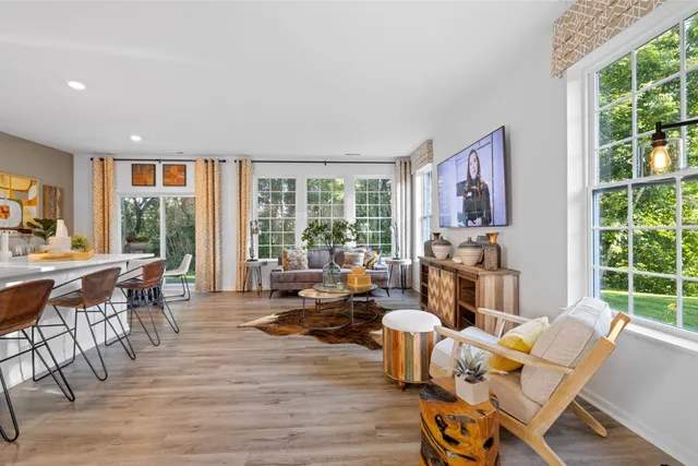 a living room with furniture and large windows