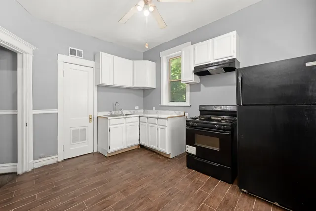 a kitchen with a stove a sink and a refrigerator