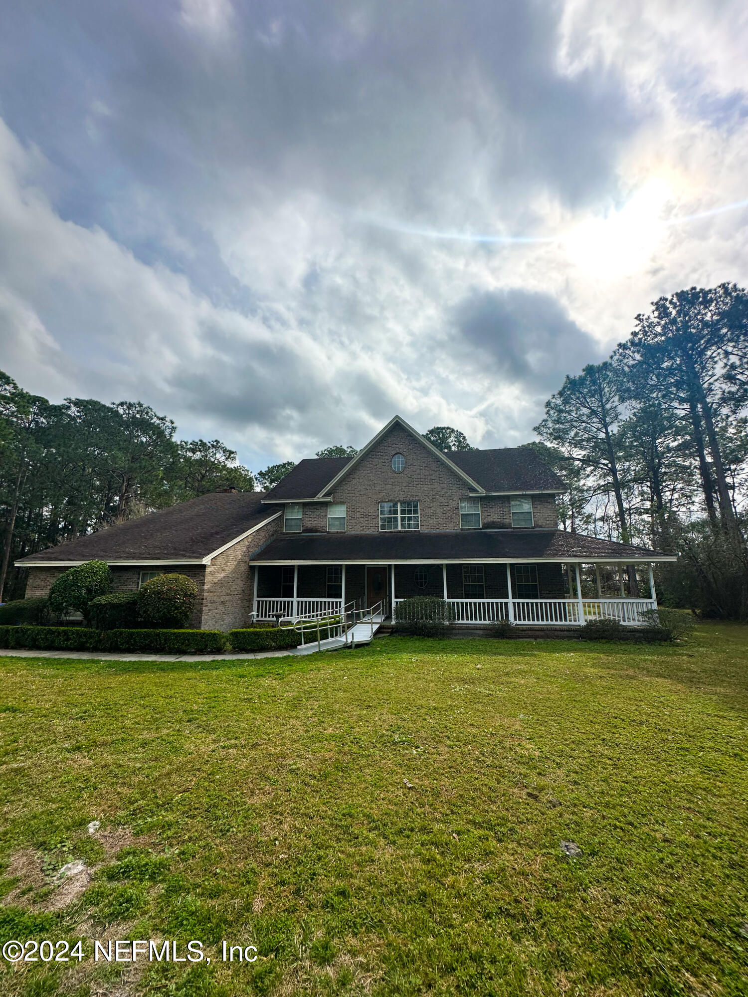 10601 Quail Ridge Drive Ponte Vedra, FL 32081 - Photo 3 of 17 a view of a swimming pool with lawn chairs and large trees