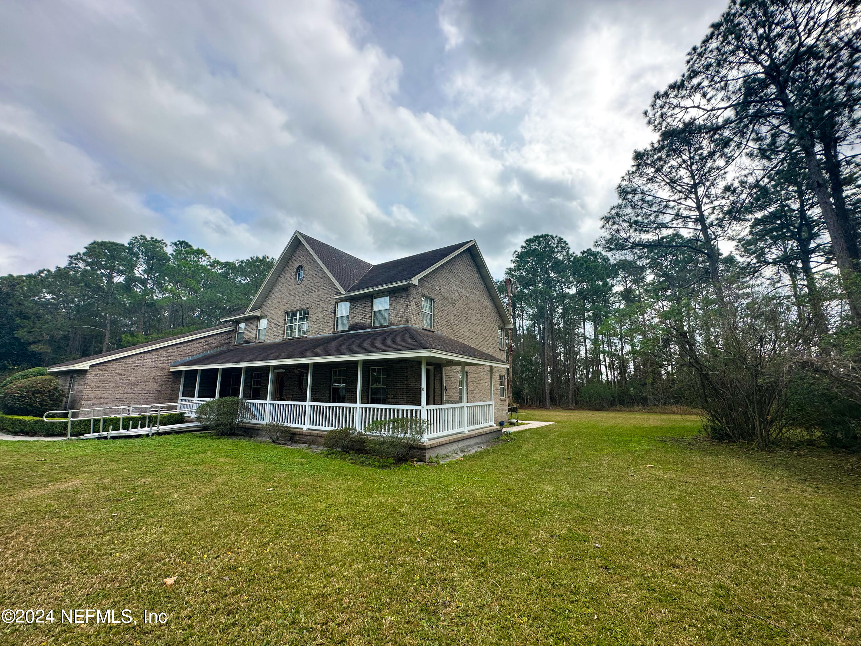 10601 Quail Ridge Drive Ponte Vedra, FL 32081 - Photo 4 of 17 a view of a house with a garden and yard