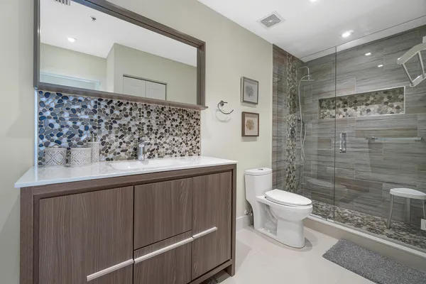 a bathroom with a sink toilet and shower