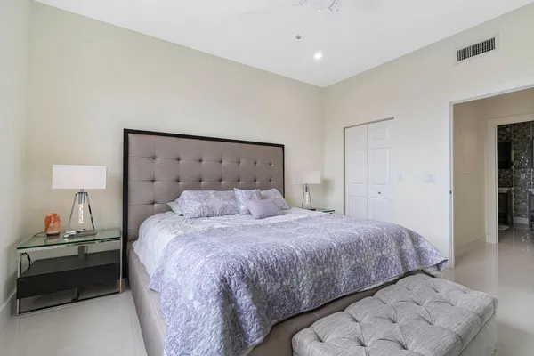 a bedroom with a bed and a lamp