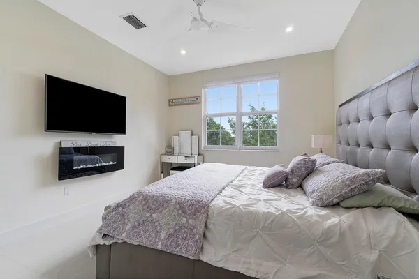 a bedroom with a bed and a flat screen tv