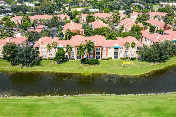a view of a house with a yard and lake view