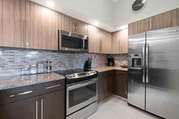 a kitchen with a sink stove and refrigerator