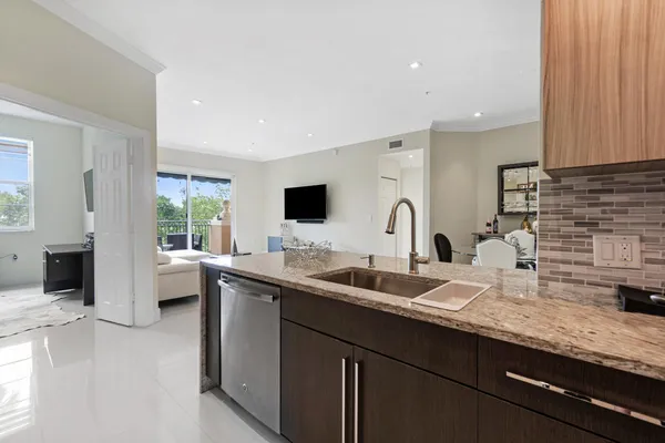 a kitchen with a sink and a wooden floor