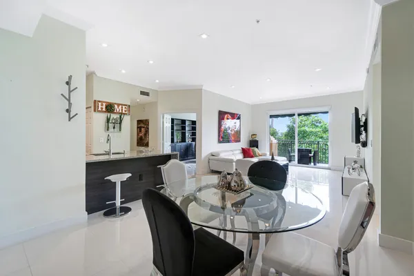 a living room with furniture potted plant and a large window