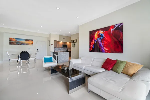 a living room with furniture and a painting