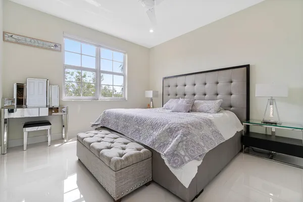 a bedroom with a large bed and a couch
