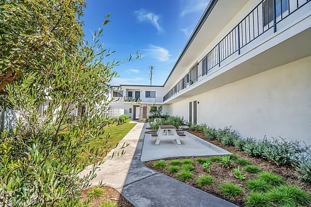 a view of house with yard outdoor seating and stairs