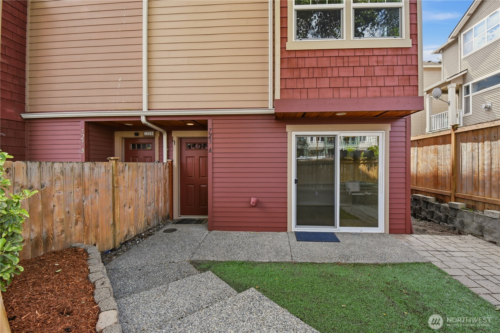 723 North 95th Street, Unit A Seattle, WA 98103 - Photo 20 of 20 a view of a brick house with a yard