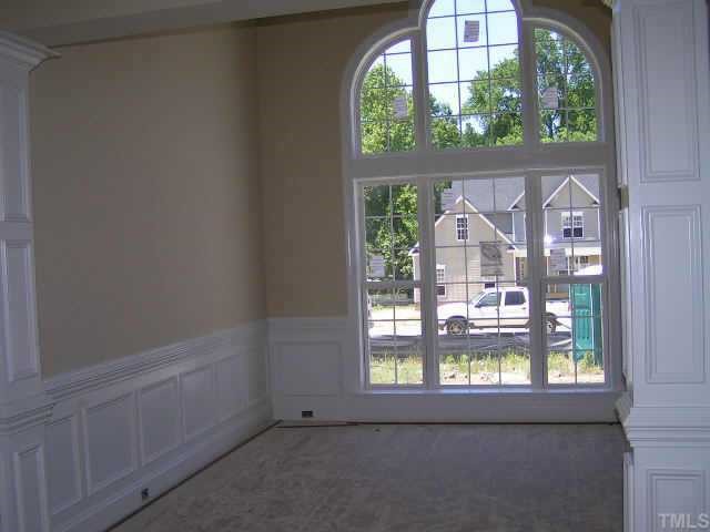 2438 Rolling Tracks Road Willow Spring, NC 27592 - Photo 2 of 8 an empty room with a window