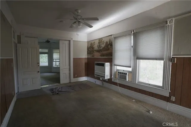 an empty room with a empty space and windows