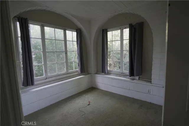 an empty room with a empty space and windows