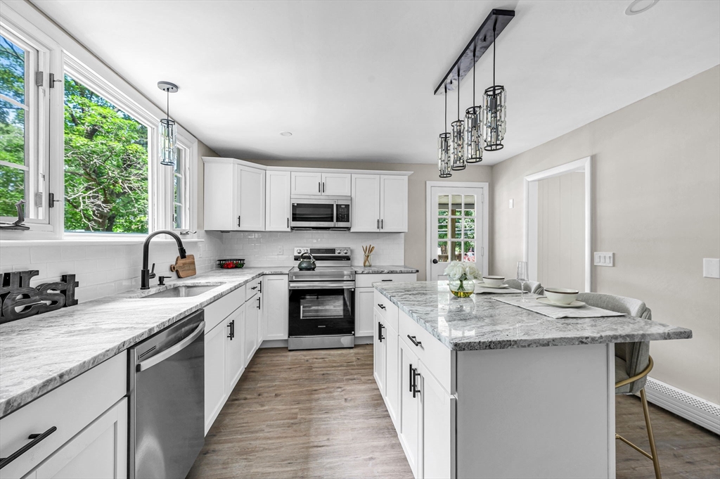 37 Bridge Street Monson, MA 01057 - Photo 34 of 35 a kitchen with kitchen island granite countertop a sink appliances cabinets and a counter top space