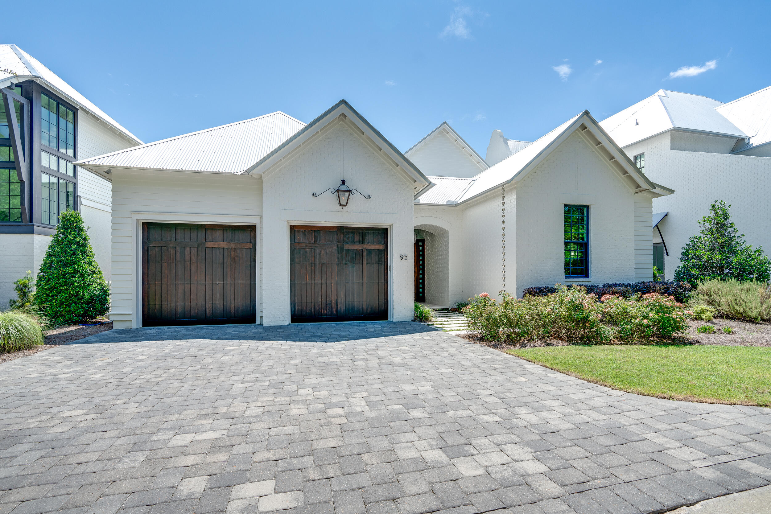 95 Tyler Santa Rosa Beach, FL 32459 - Photo 3 of 58 a front view of a house with a yard and garage